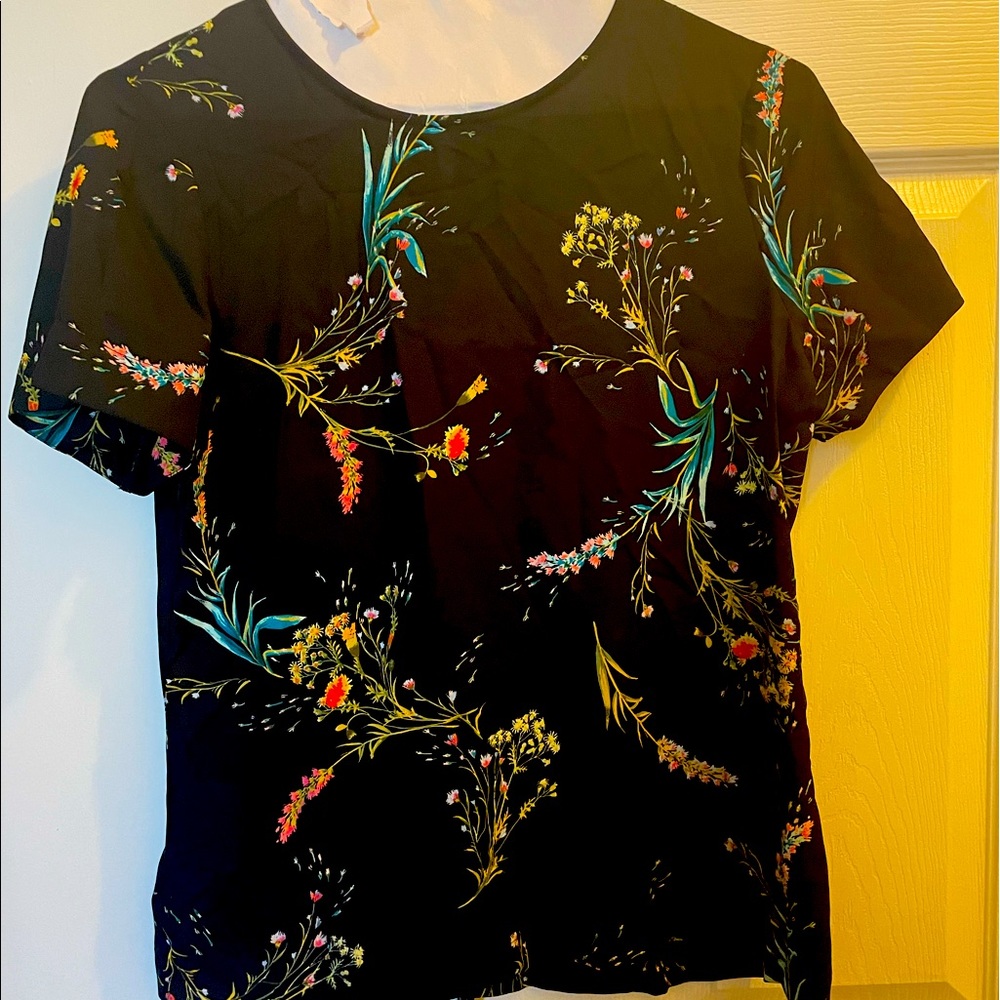 Black blouse with flowers and small whole with button in back size small